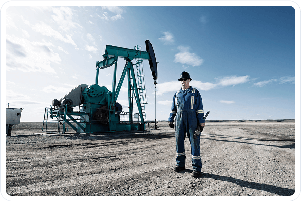worker in front of pump rig