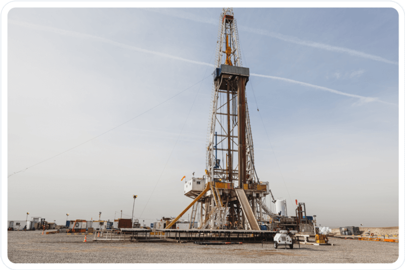 Hydraulic fracking drilling rig situated in a vast open field.
